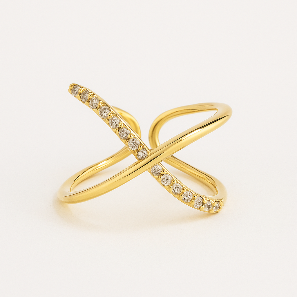 Gold ring with diamond accents on a light beige background