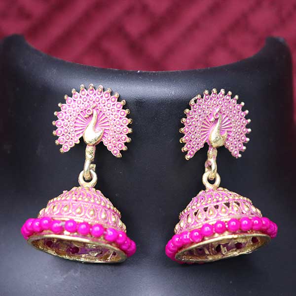 A pair of pink jhumki earrings with coral peacock designs, displayed on a mannequin.