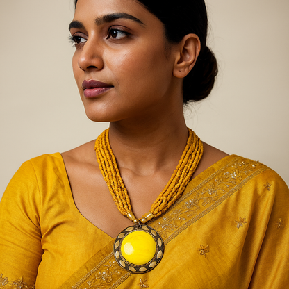 Woman wearing a yellow saree with a matching necklace against a beige background