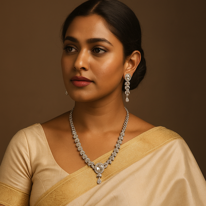 Woman wearing a beige saree with jewelry against a brown background