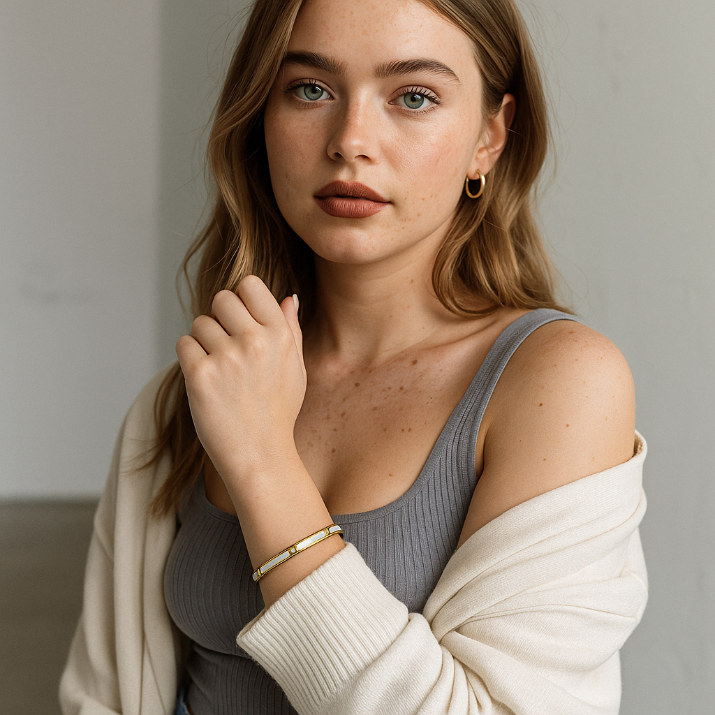 Woman wearing a gray top and beige cardigan with a 18K Gold Plated thin Bangle Bracelet