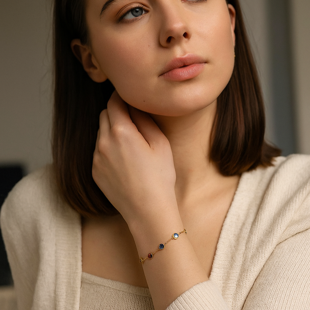 Woman wearing a delicate 18k Gold Anti Tarnish bracelet with colorful stones, close-up of her hand and neck.