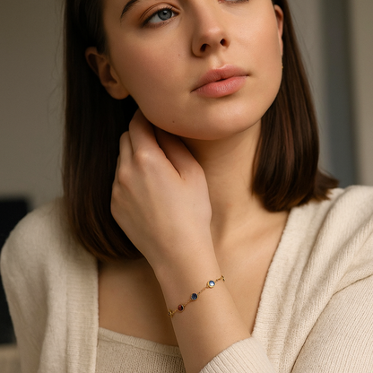 Woman wearing a delicate 18k Gold Anti Tarnish bracelet with colorful stones, close-up of her hand and neck.