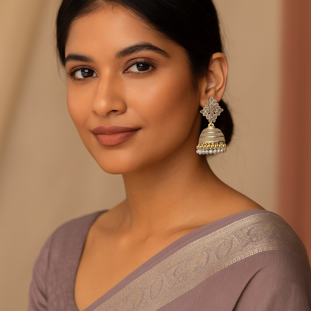 Woman wearing a saree with a floral earring against a beige background