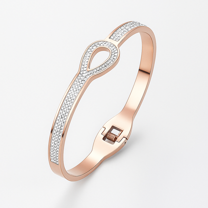 Rose gold bracelet with diamond accents on a light gray background