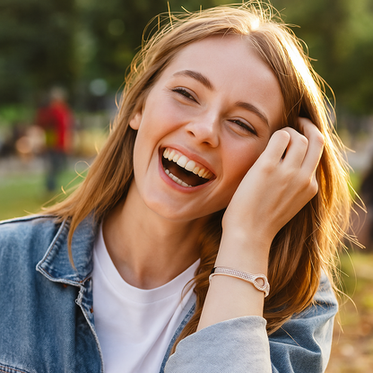 Woman laughing outdoors with a blurred background