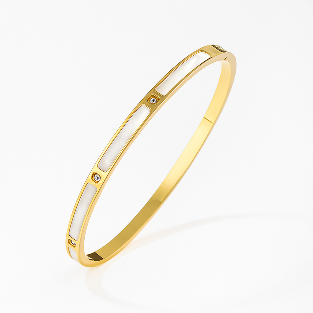 Gold bracelet with white interior on a light beige background