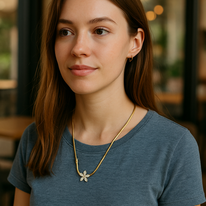 Woman wearing a blue shirt and gold necklace in an indoor setting