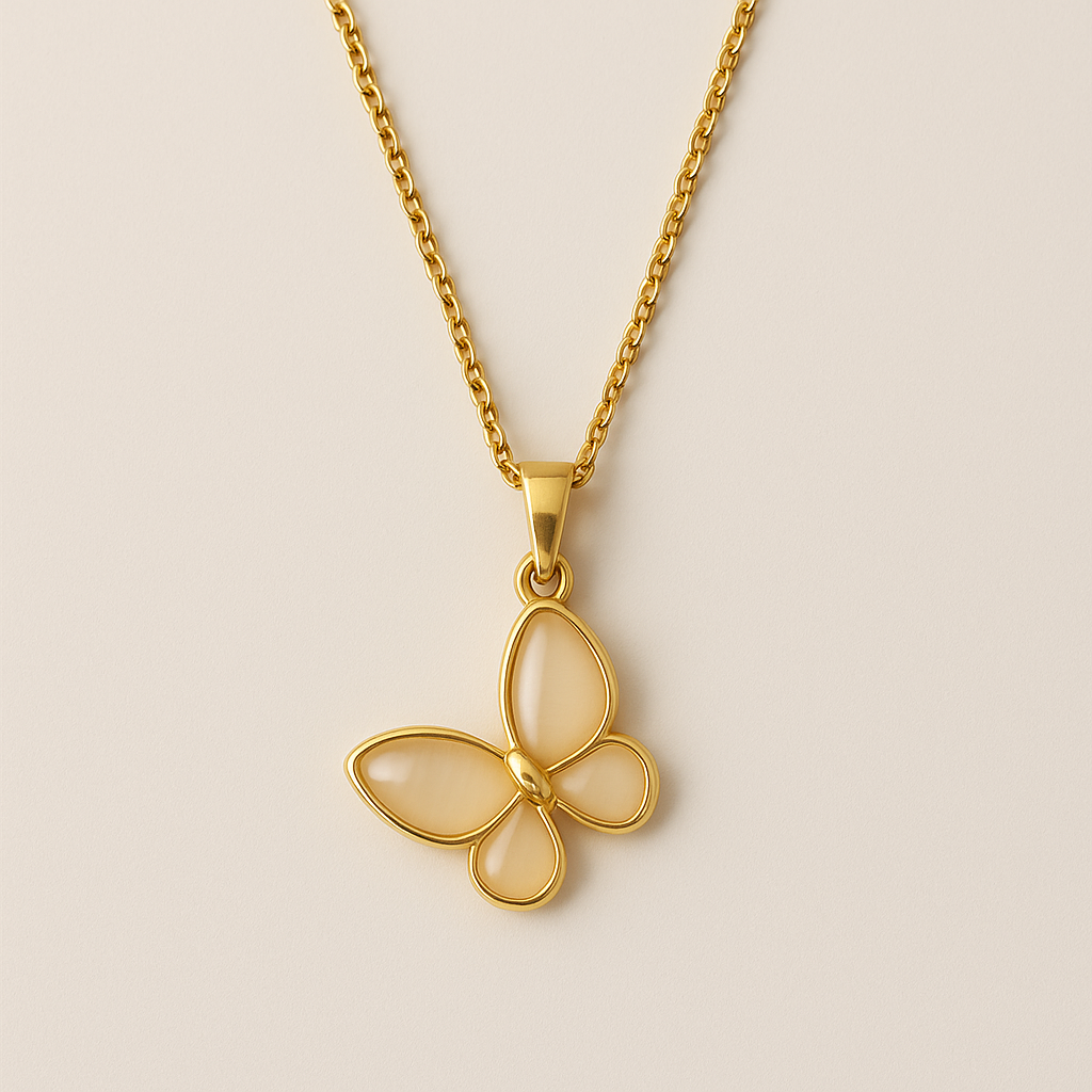 Gold butterfly pendant necklace on a beige background