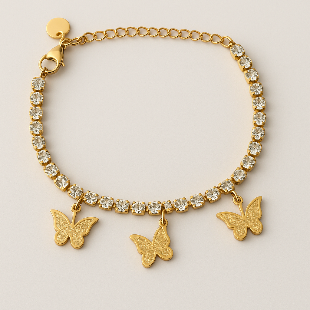 Gold bracelet with crystal beads and butterfly charms on a light background