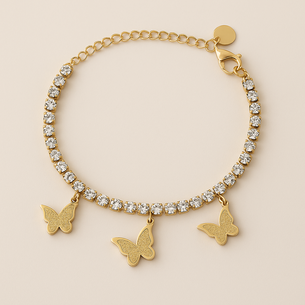 Gold bracelet with crystal beads and butterfly charms on a beige background