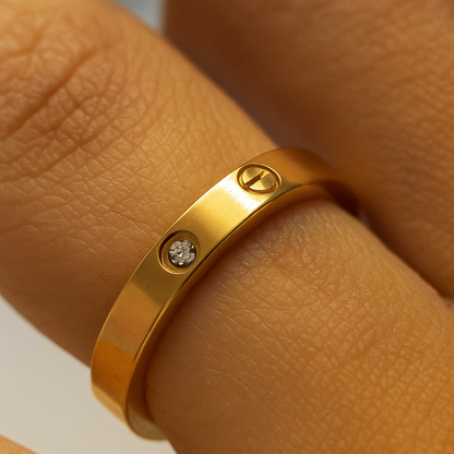 Gold ring with a diamond on a person's finger