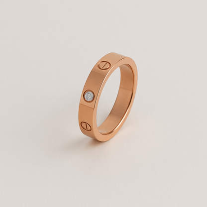 Rose gold ring with a diamond on a light beige background