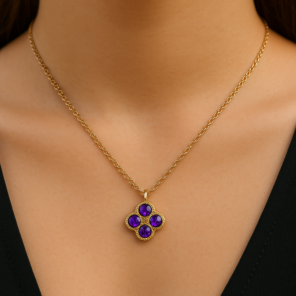 Gold necklace with a purple gemstone pendant on a model