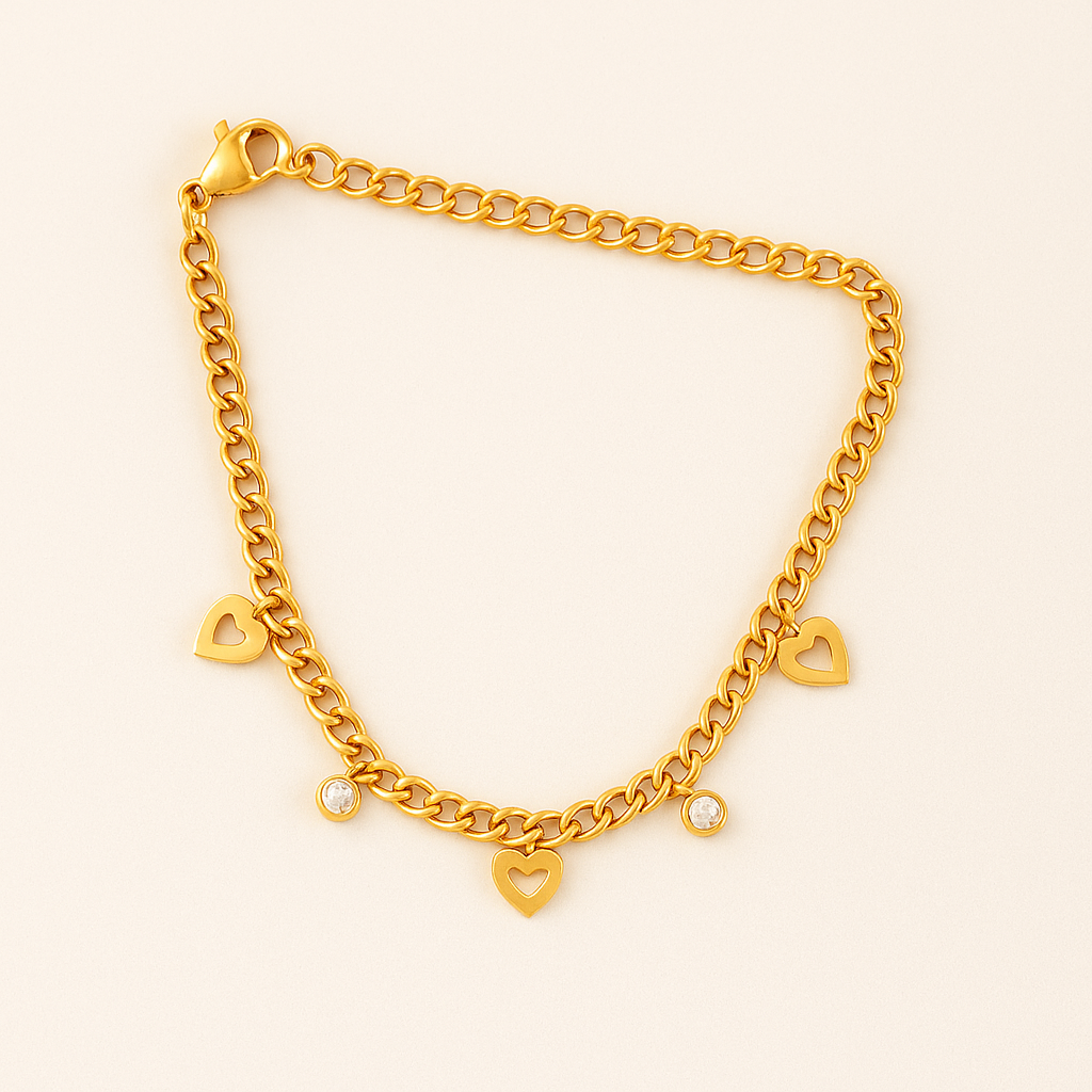 Gold chain bracelet with heart-shaped charms on a light beige background