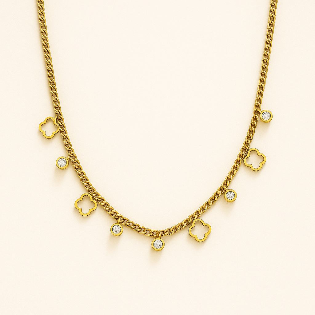 Gold necklace with clover-shaped charms on a beige background