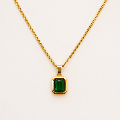 18K Gold necklace with a green gemstone pendant on a white background