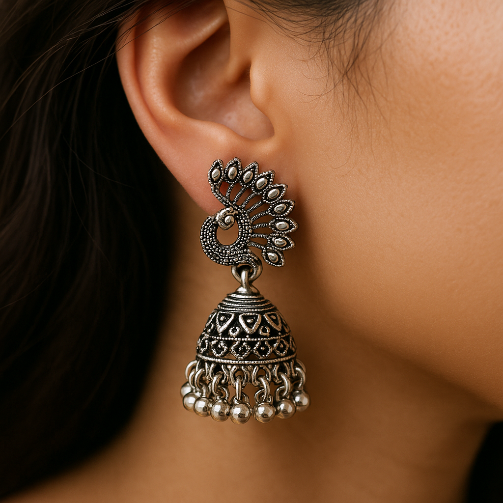 Close-up of a person wearing an ornate silver earring.
