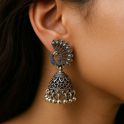 Close-up of a person wearing an ornate silver earring.