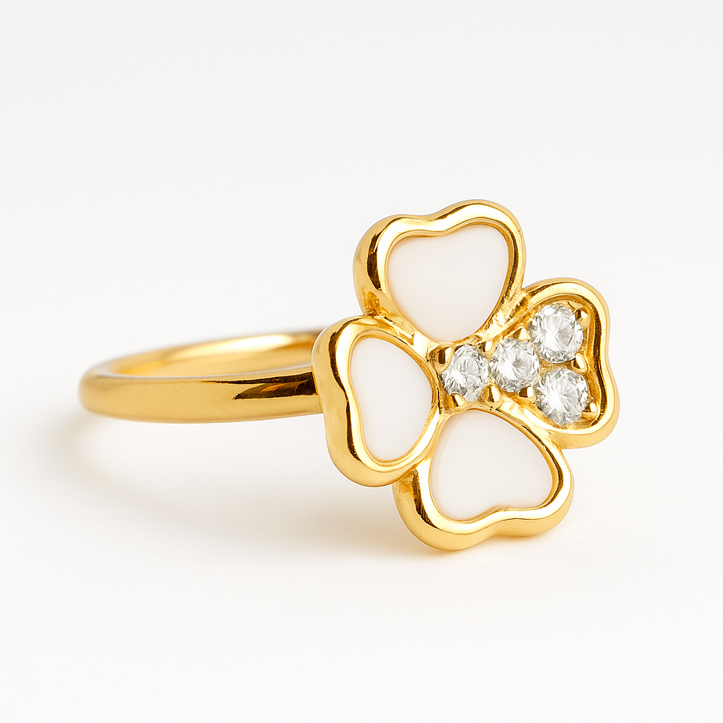 Gold ring with a clover design and white stones on a light background