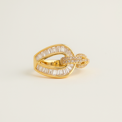 Gold ring with diamond accents on a beige background