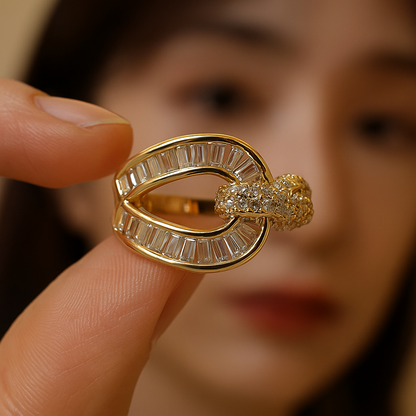 Gold ring with diamonds held by a finger against a blurred background
