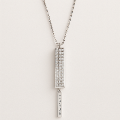 Silver necklace with a rectangular pendant and 'I LOVE YOU' tag on a light gray background