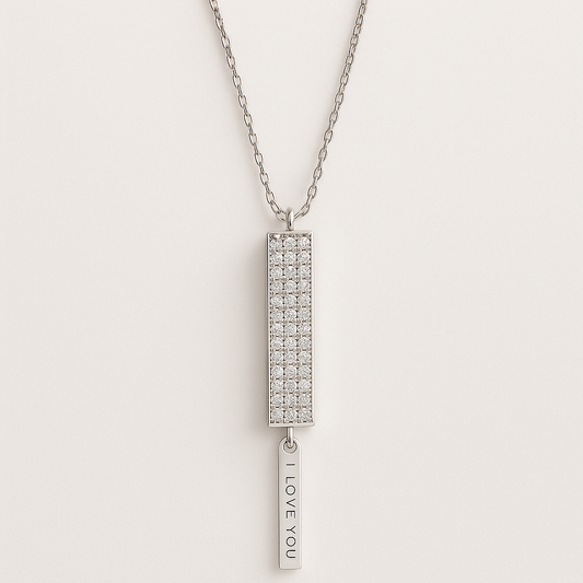 Silver necklace with a rectangular pendant and 'I LOVE YOU' tag on a light gray background