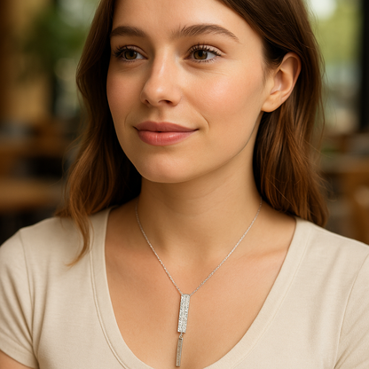 Woman wearing a silver necklace with a blurred background