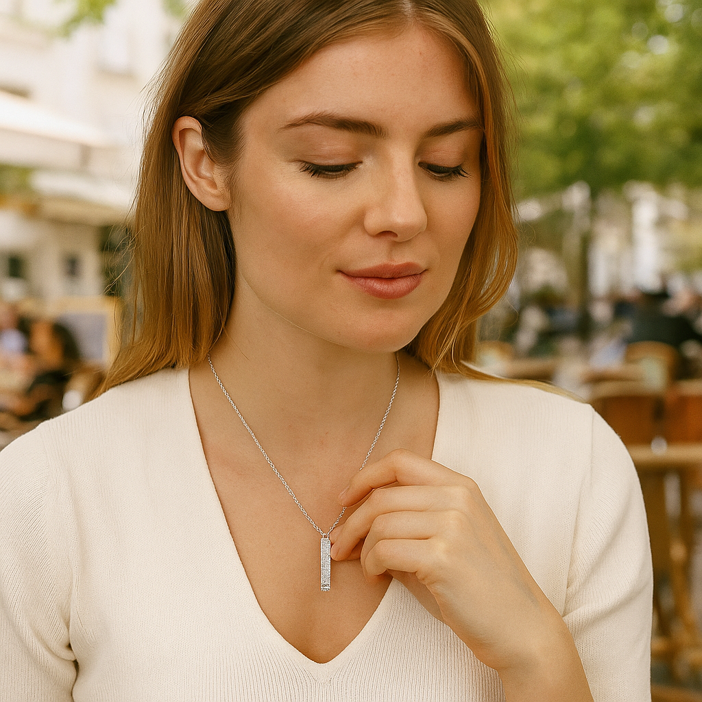 Woman wearing a silver necklace outdoors with blurred background