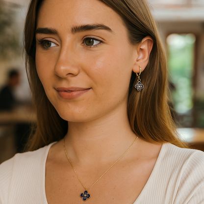 Close-up of a woman wearing a necklace with a pendant, indoors.