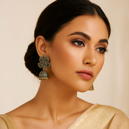 Woman wearing traditional earrings against a beige background