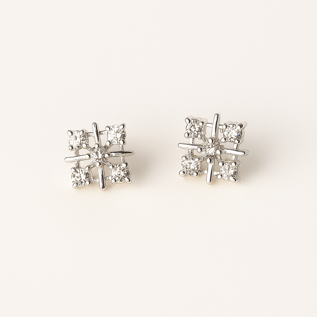 Pair of diamond stud earrings on a light gray background