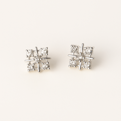 Pair of diamond stud earrings on a light gray background