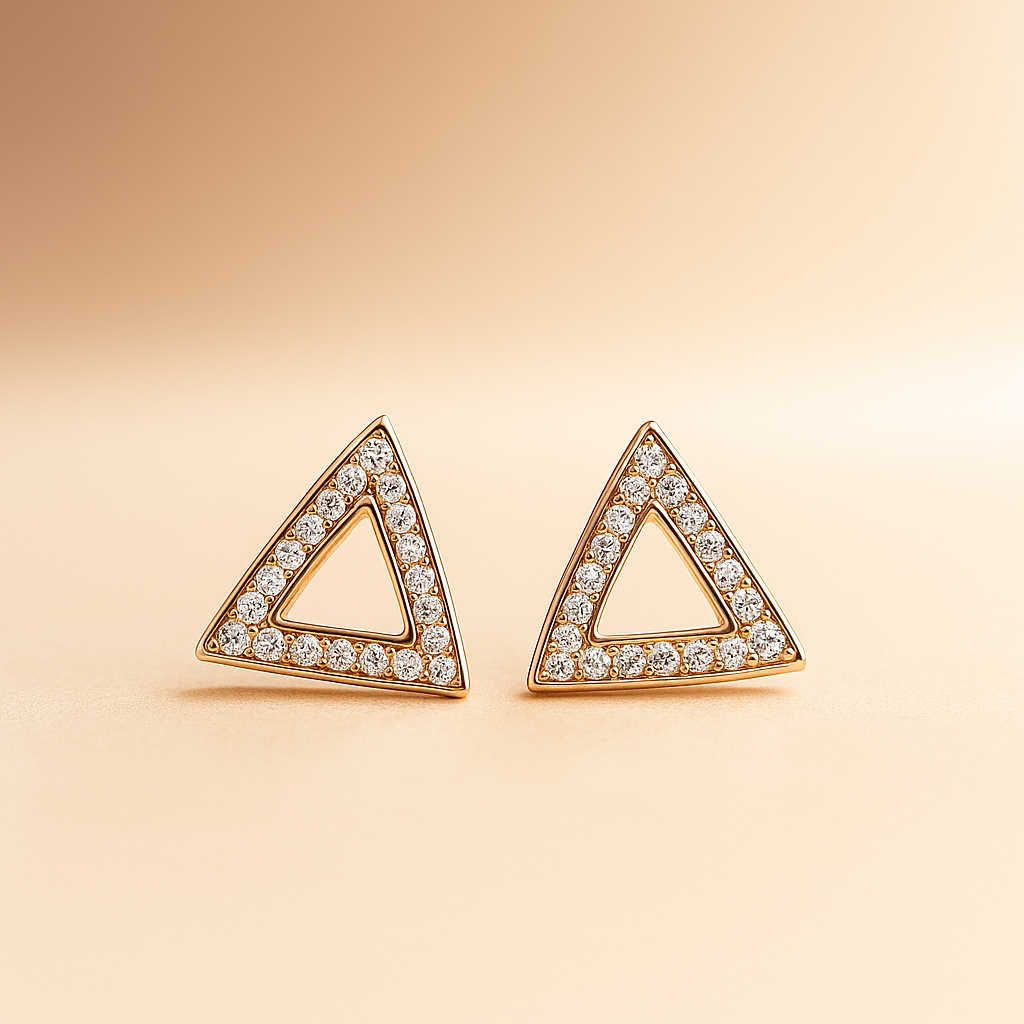 Triangle-shaped earrings with diamond accents on a beige background