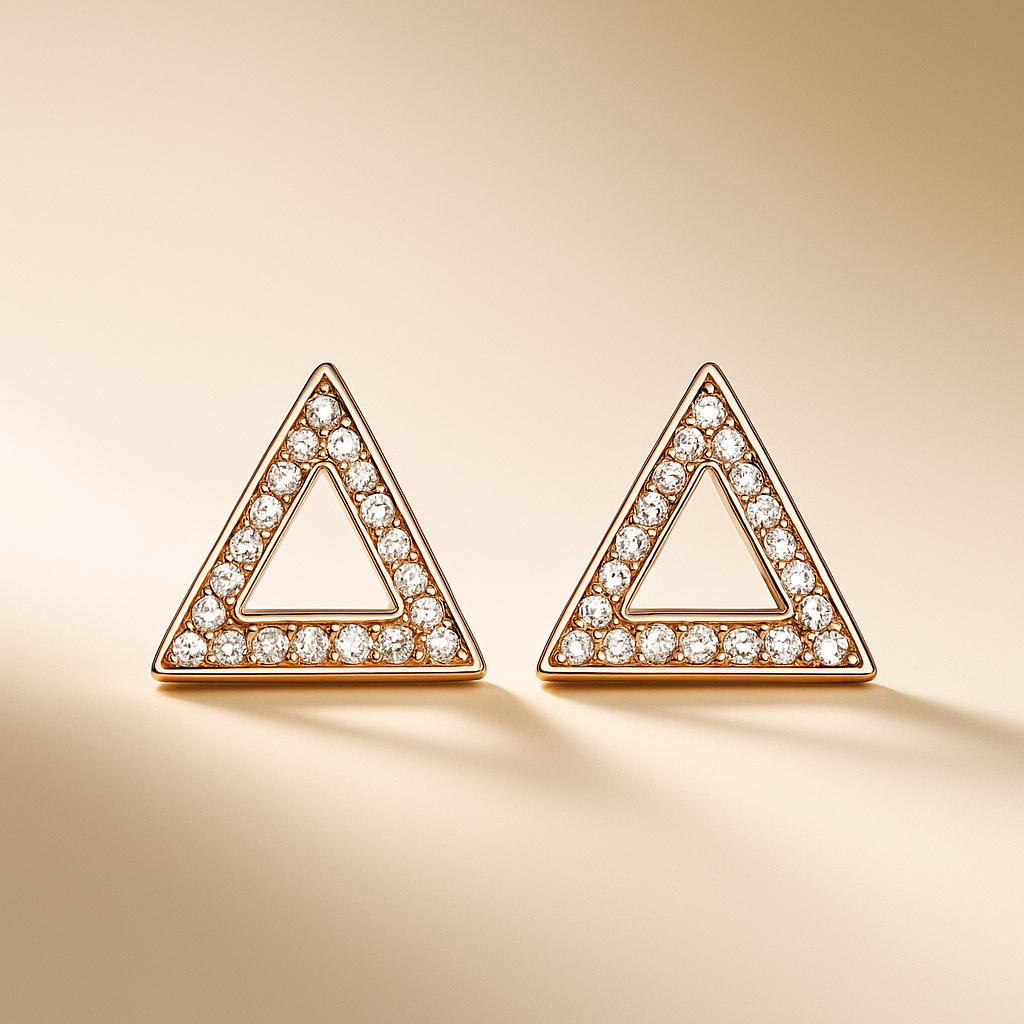 Triangle-shaped earrings with diamond accents on a beige background