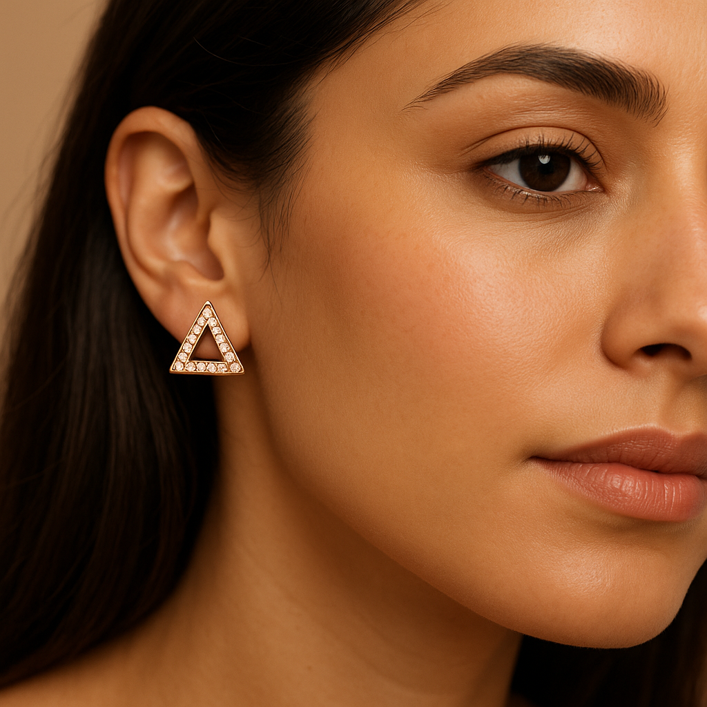 Close-up of a woman wearing a triangle-shaped earring with a beige background