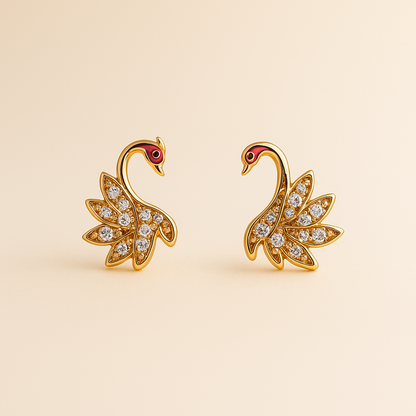 Gold swan earrings with gemstones on a beige background