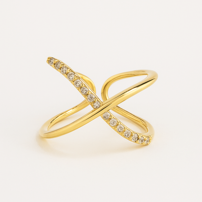 Gold ring with diamond accents on a light beige background