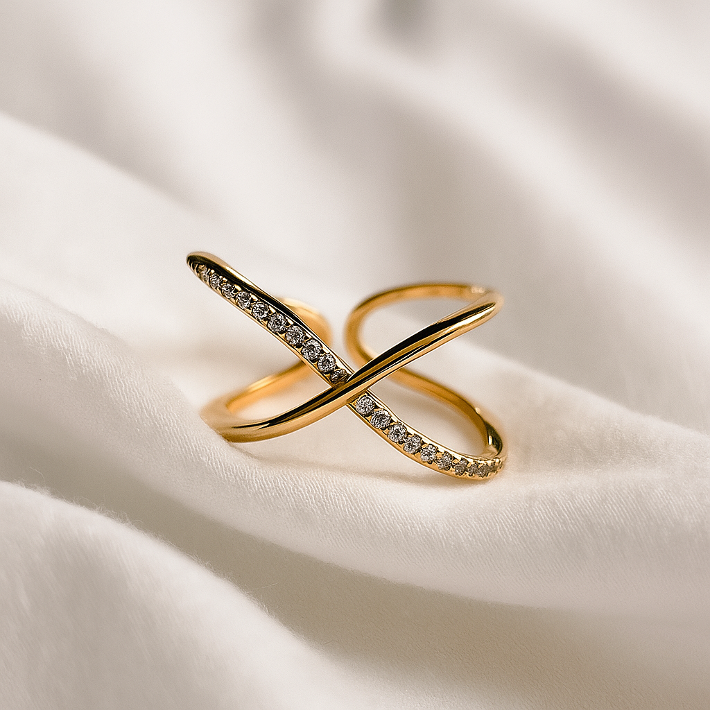 Gold ring with diamond accents on a white fabric background