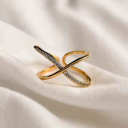 Gold ring with diamond accents on a white fabric background