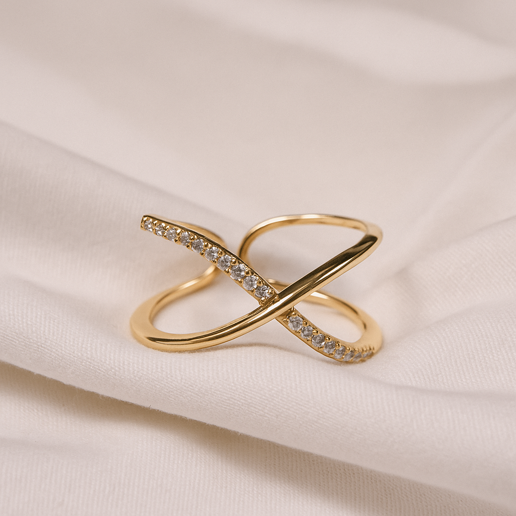 Gold ring with diamond accents on a beige fabric background