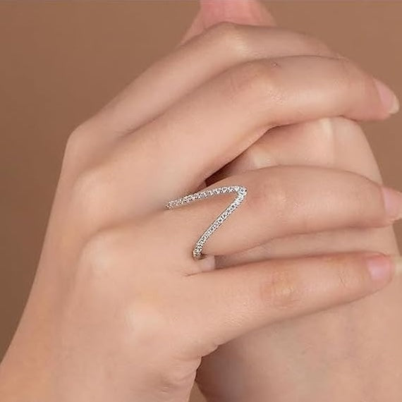 A person wearing an 18Kt gold chevron ring on their finger, showcasing the design and fit.