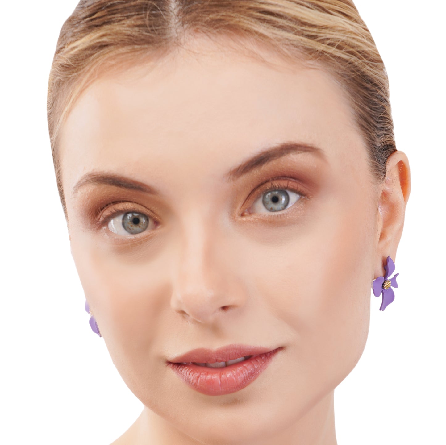 A woman's face with focus on her earrings, which are purple flower designs.
