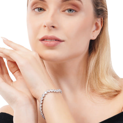 Woman wearing a silver bracelet with a white background