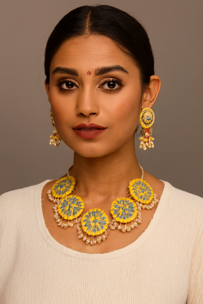 Woman wearing a yellow and green floral necklace and earrings against a brown background