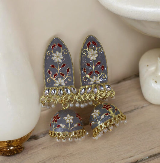 A pair of gray Meenakari earrings with floral patterns and gold accents, displayed against a white background.