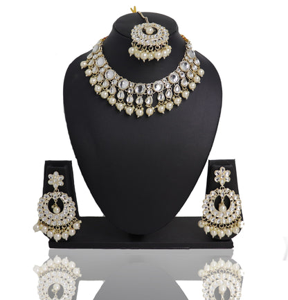 A Pearl Monalisa Choker Set displayed on a mannequin bust, consisting of a necklace, earrings, and a mangtikka, with a reflective white surface and gold accents.