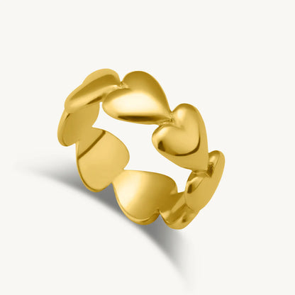 A gold-colored ring with a design of interlocking heart shapes.