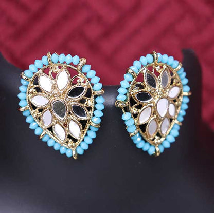 A pair of sky blue kundan style stud earrings with gold accents displayed on a mannequin.